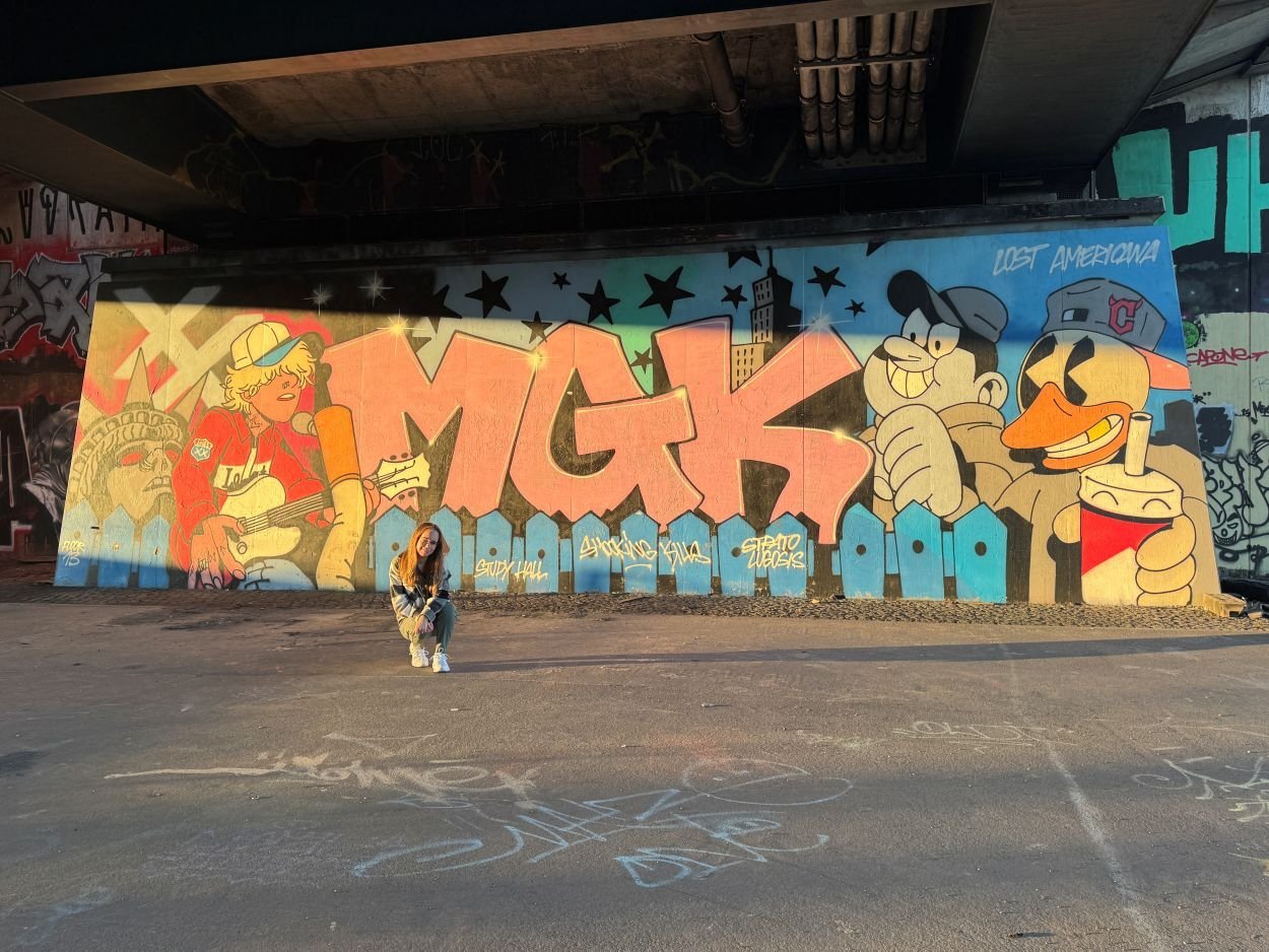AIFS Teilnehmerin vor ihrem Auslandsaufenthalt vor einer Wand mit Graffiti